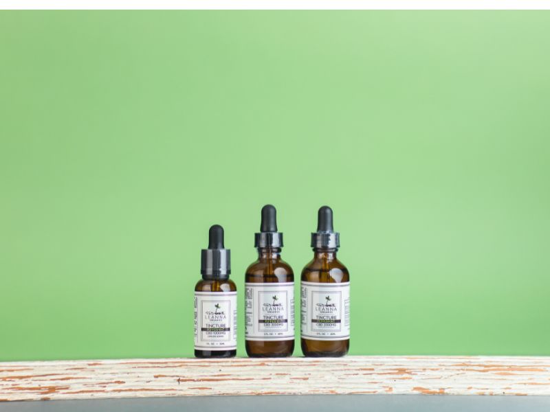 Leanna Organics CBD oil sitting on a shelf with a green background
