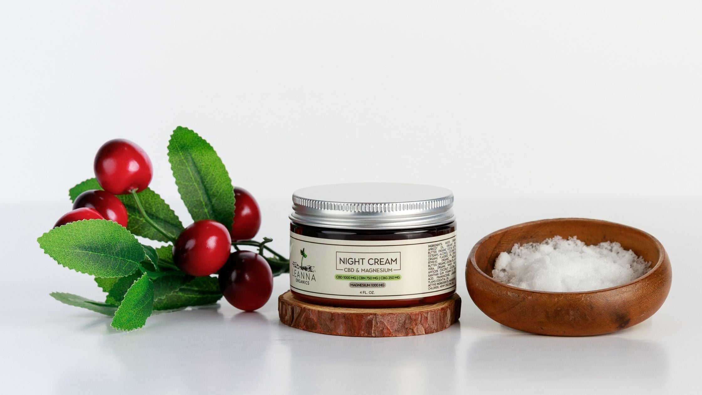 Leanna Organics CBD magnesium cream next to a bowl and some fruit.