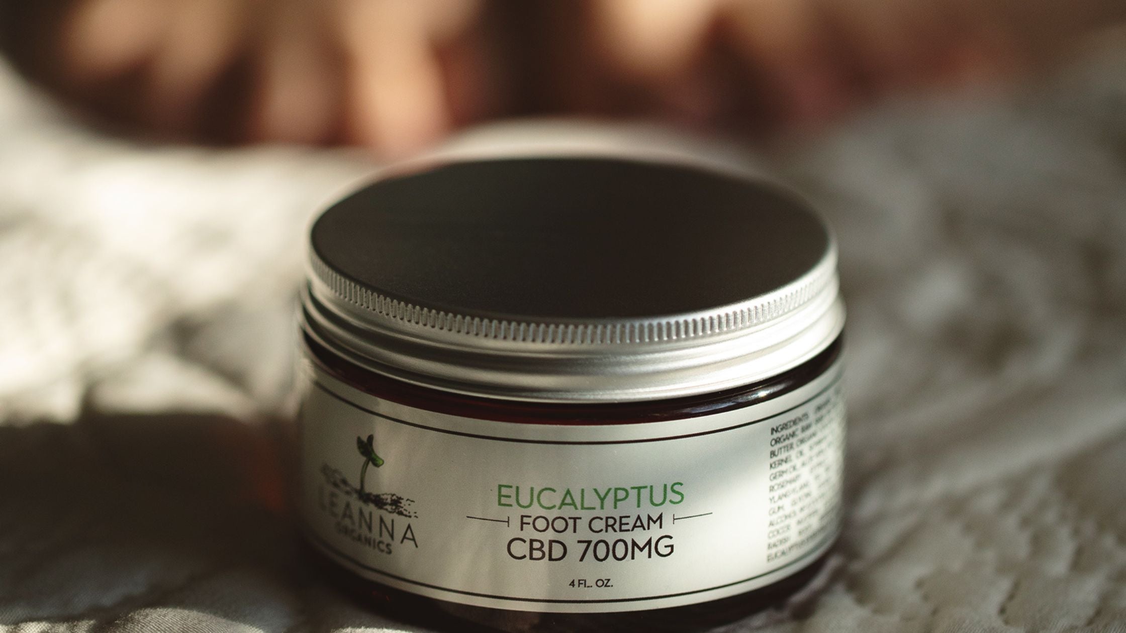 Someone using Leanna Organics CBD foot cream