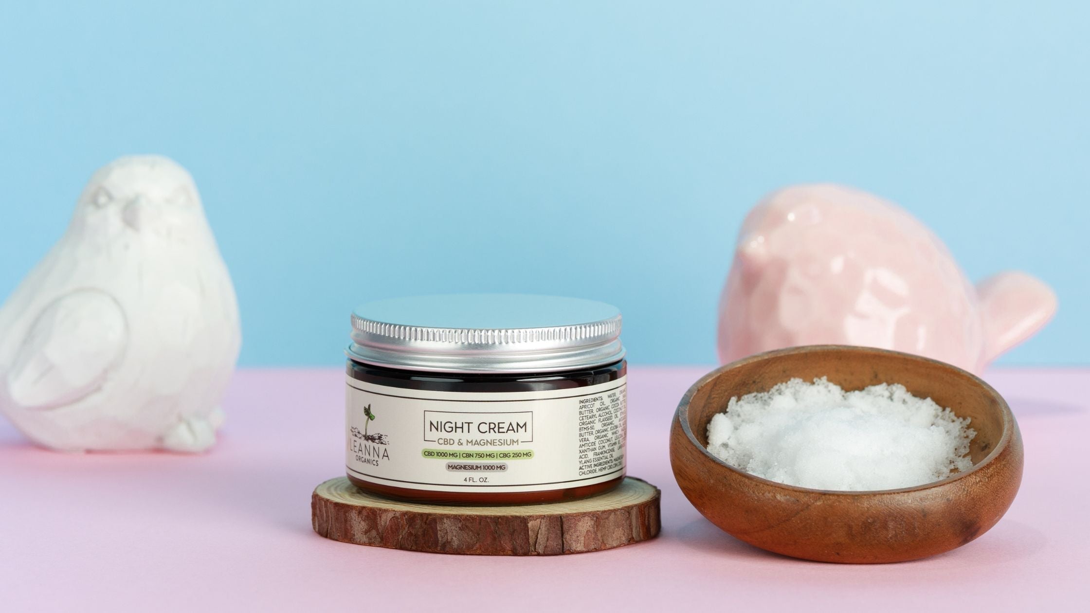 Leanna Organics CBD magnesium cream with a bowl of magnesium and two birds behind it.