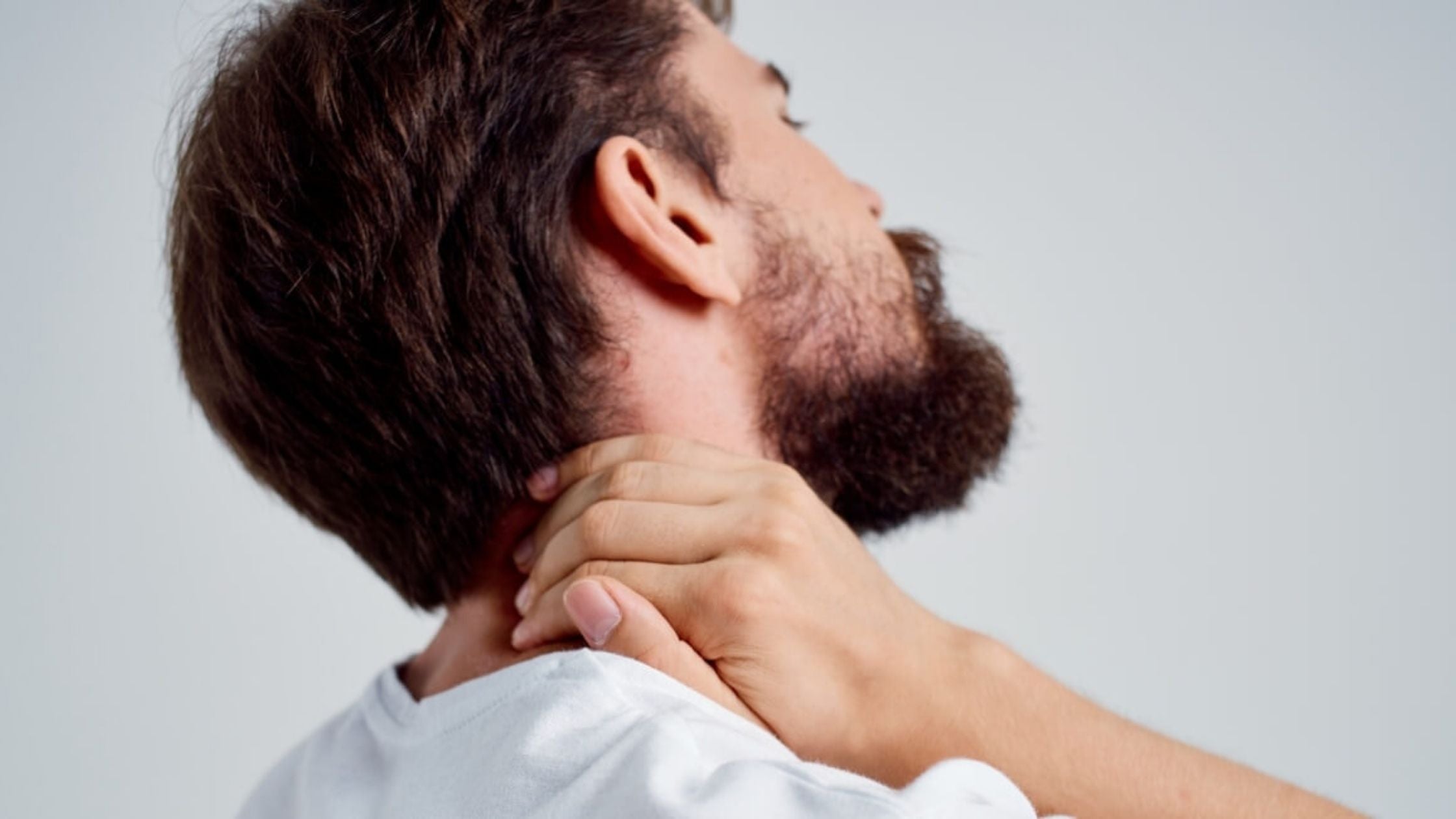 Man holding his neck in pain