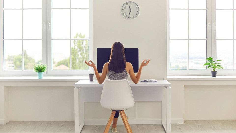 Lady sitting at her desk sressed.