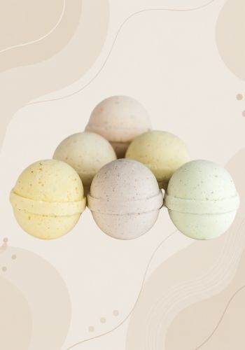 Set of CBD bath bombs in pastel colors on a neutral background