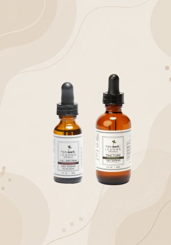 Two CBD tincture bottles on a beige background