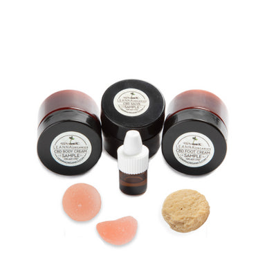 Collection of Leanna Organics CBD samples, including salve, gummies, and dog treats.